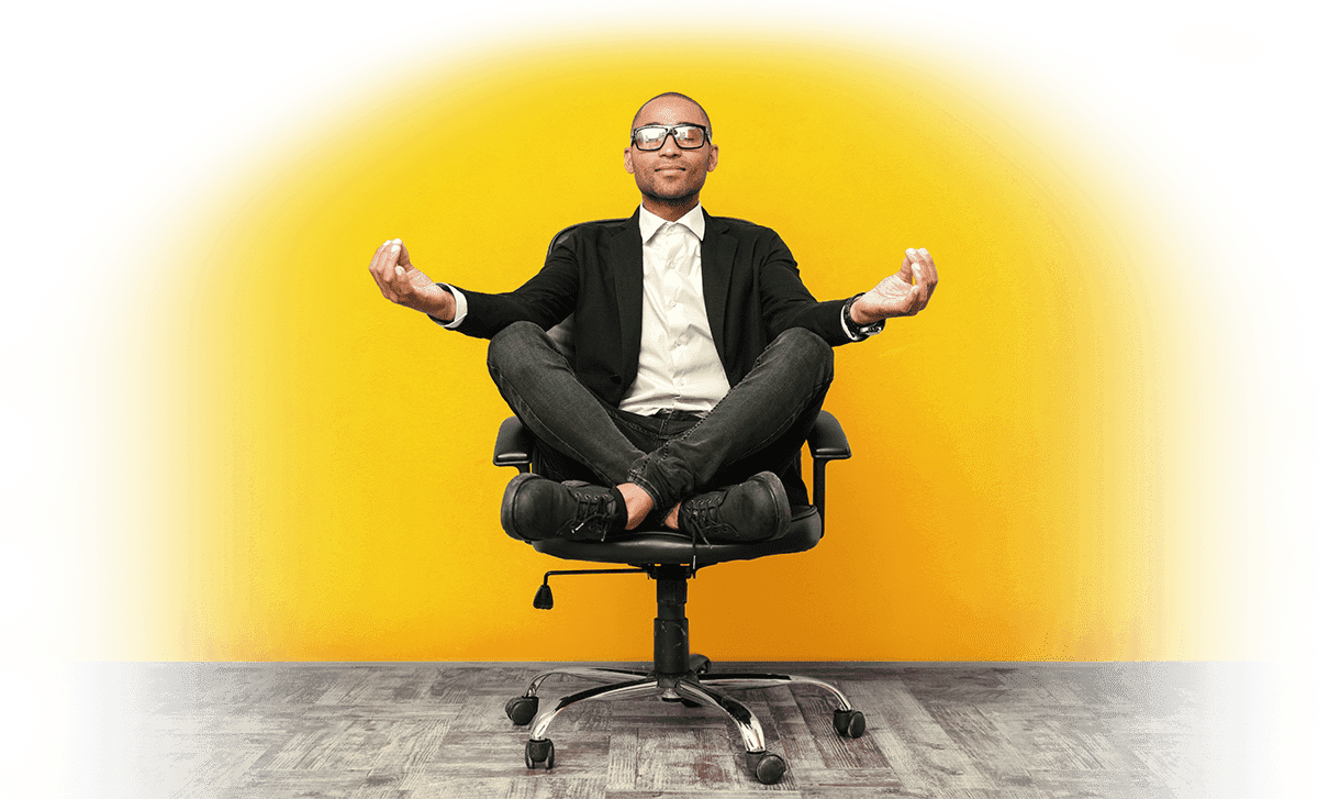 Man meditating in office chair in peace