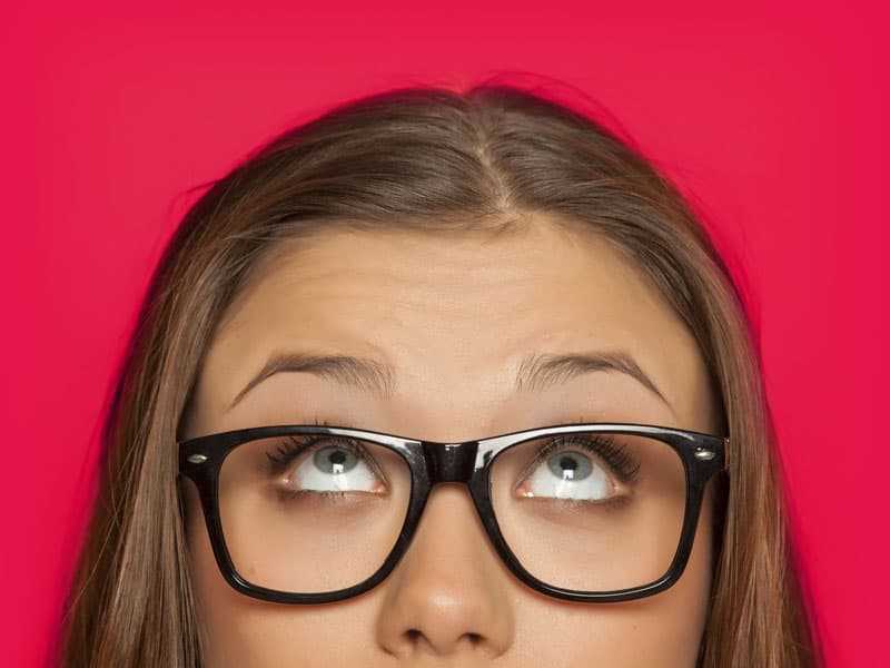 Woman with healthy bright eyes looking up